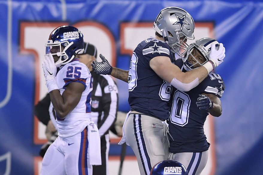 Dallas Cowboys tight end Blake Jarwin, center, celebrates with wide receiver Tavon Austin after scoring a touchdown against the New York Giants during the second quarter of an NFL football game, Monday, Nov. 4, 2019, in East Rutherford, N.J. (AP Photo/Bill Kostroun)