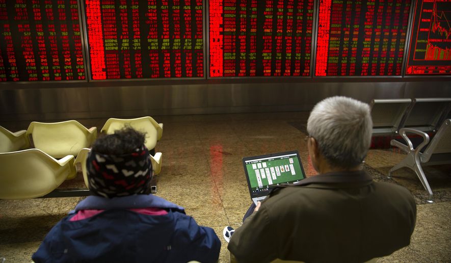 A Chinese investor uses a laptop as he monitors stock prices at a brokerage house in Beijing, Monday, Nov. 4, 2019. Asian stock markets followed Wall Street higher Monday after unexpectedly strong U.S. jobs data helped to soothe worries American factory activity was weaker than forecast. (AP Photo/Mark Schiefelbein)
