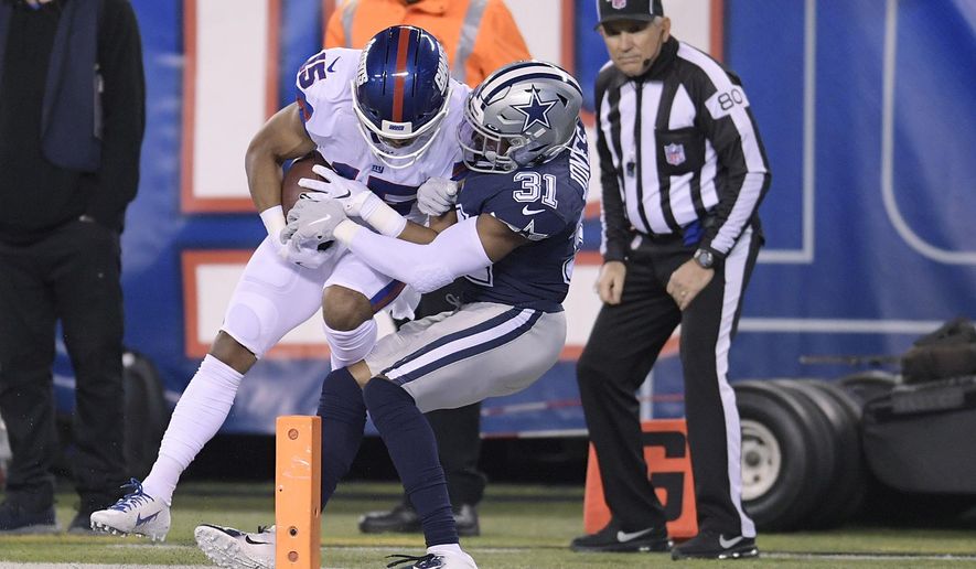 New York Giants wide receiver Golden Tate (15) comes down with a catch just in front of the goal line against Dallas Cowboys cornerback Byron Jones (31) during the second quarter of an NFL football game, Monday, Nov. 4, 2019, in East Rutherford, N.J. (AP Photo/Bill Kostroun)