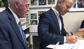 Democratic presidential candidate former U.S. Rep. John Delaney, D-Md., files to be listed on the ballot for the New Hampshire primary beside New Hampshire Secretary of State Bill Gardner, left, Monday, Nov. 4, 2019, in Concord, N.H. (AP Photo/Hunter Woodall)