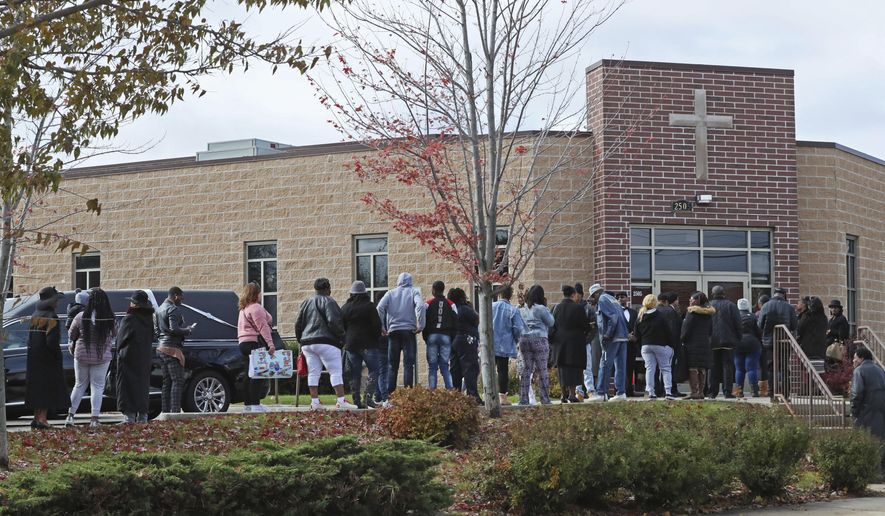 People line up Monday, Nov. 4, 2019 to attend the visitation and funeral of sisters A'Lisa "Lisa" Z. Gee age 6, and Amea N. Gee age 4, who were struck and killed by a hit and run driver while crossing the street. The funeral was held at Jerusalem Missionary Baptist Church in Milwaukee. Their cousin Drevyze Rayford was also seriously injured in the accident. (Michael Sears/Milwaukee Journal-Sentinel via AP)