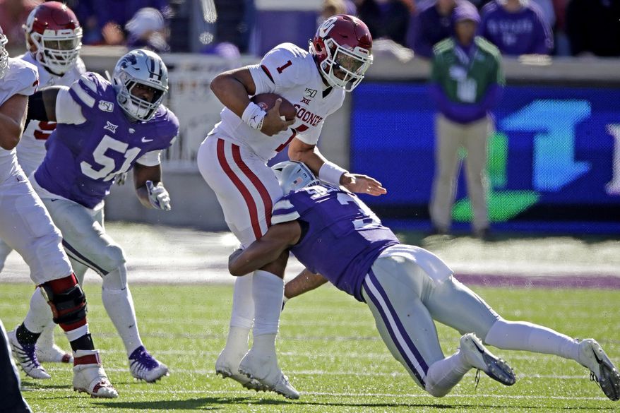 Oklahoma quarterback Jalen Hurts (1) is tackled by Kansas State linebacker Elijah Sullivan (3) during the second half of an NCAA college football game Saturday, Oct. 26, 2019, in Manhattan, Kan. Kansas State won 48-41. (AP Photo/Charlie Riedel)