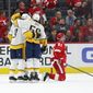 Nashville Predators center Matt Duchene (obscured) celebrates his goal with Filip Forsberg (9) and Roman Josi (59) as Detroit Red Wings center Frans Nielsen (81) kneels on the ice in the second period of an NHL hockey game Monday, Nov. 4, 2019, in Detroit. (AP Photo/Paul Sancya)