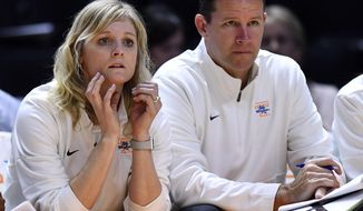 In this Tuesday, Oct. 29, 2019, photo, Tennessee women&#39;s basketball coach Kellie Harper and assistant coach Jon Harper watch the team&#39;s exhibition game against Carson-Newman in Knoxville, Tenn. “Playing at Tennessee was extremely important for me to understand the culture at a deeper level than if I had not played here,” Harper said. “It’s just a special place, I think. I hope people can see my passion for the program and this team and what has come before. It just means more, I think, to alums.” (Saul Young/Knoxville News Sentinel via AP)