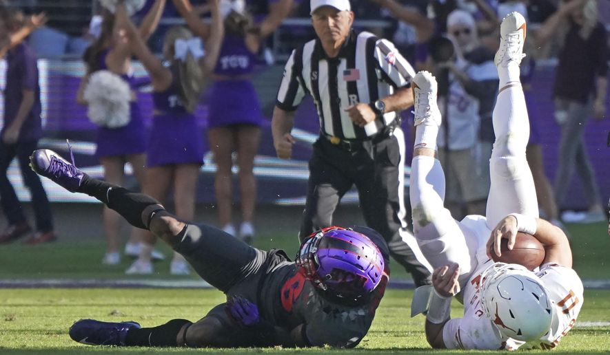 TCU safety Innis Gaines (6) upends Texas quarterback Sam Ehlinger (11) in the second half of an NCAA college football game in Fort Worth, Texas, Saturday, Oct. 26, 2019. (AP Photo/Louis DeLuca)