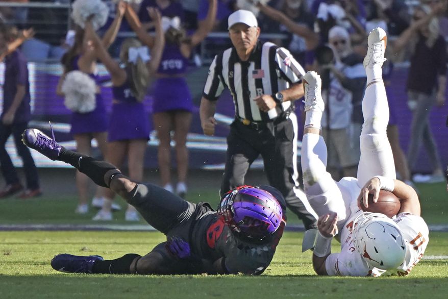 TCU safety Innis Gaines (6) upends Texas quarterback Sam Ehlinger (11) in the second half of an NCAA college football game in Fort Worth, Texas, Saturday, Oct. 26, 2019. (AP Photo/Louis DeLuca)