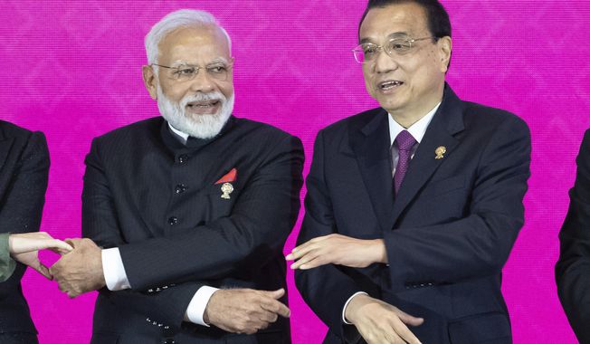 Indian Prime Minister Narendra Modi, left, and Chinese Premier Li Keqiang pose for a group photo at The Regional Comprehensive Economic Partnership Association of Southeast Asian Nations (ASEAN) summit in Nonthaburi, Thailand, Monday, Nov. 4, 2019. (AP Photo/Wason Wanichakorn)