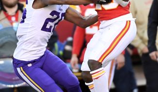 Kansas City Chiefs wide receiver Tyreek Hill (10) makes a 41-yard catch against Minnesota Vikings cornerback Trae Waynes (26) during the second half of an NFL football game in Kansas City, Mo., Sunday, Nov. 3, 2019. (AP Photo/Reed Hoffmann)