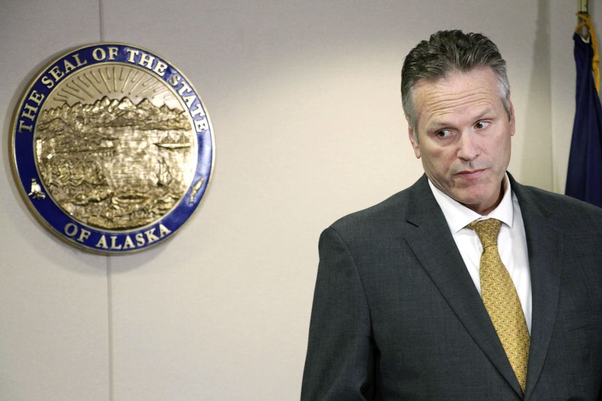 FILE - In this Sept. 26, 2019 file photo, Alaska Gov. Mike Dunleavy announces at a news conference in Anchorage, Alaska, that he has signed an administrative order directing state officials to create a program where state employees can opt in or out from having union fees and dues deducted from their checks. A group seeking to recall Alaska Gov. Mike Dunleavy is asking a judge to allow their effort to move forward. Attorneys for the Recall Dunleavy campaign, in court papers filed Tuesday, Nov. 5, 2019 say Division of Elections Director Gail Fenumiai wrongly refused to certify the recall application. (AP Photo/Mark Thiessen, File)