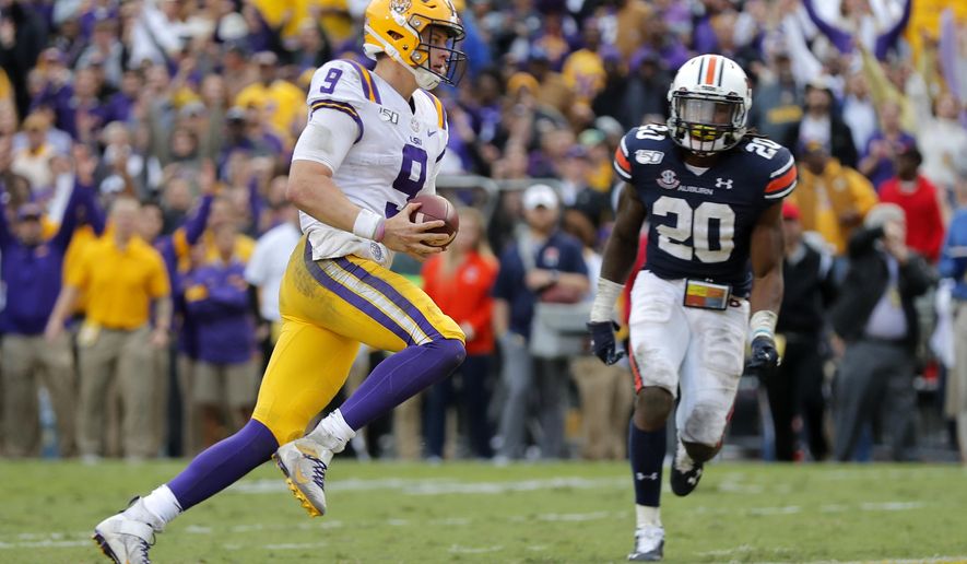 LSU quarterback Joe Burrow (9) carries for a touchdown in front of Auburn defensive back Jeremiah Dinson (20) in the second half of an NCAA college football game in Baton Rouge, La., Saturday, Oct. 26, 2019. (AP Photo/Gerald Herbert)