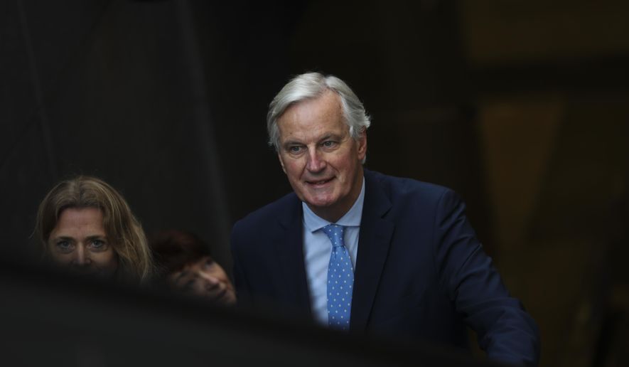 European Union chief Brexit negotiator Michel Barnier rides an escalator on his way to a meeting about Brexit outside the EU headquarters in Brussels, Friday, Oct. 25, 2019. European Union ambassadors are meeting in Brussels Friday to discuss what kind of extension to the Brexit deadline they could propose to Britain. (AP Photo/Francisco Seco)