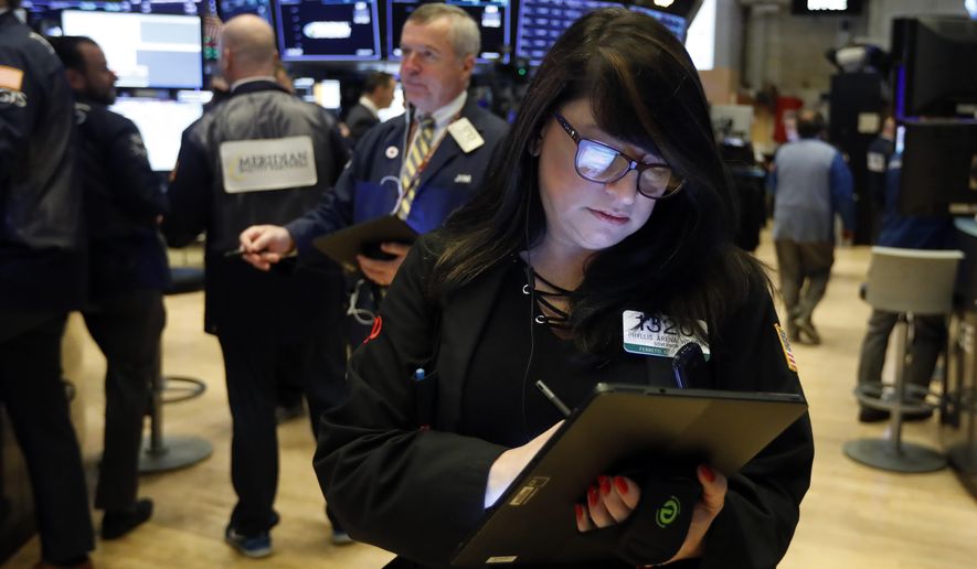 FILE - In this Oct. 30, 2019, file photo trader Phyllis Arena Woods works on the floor of the New York Stock Exchange. The U.S. stock market opens at 9:30 a.m. EST on Tuesday, Nov 5. (AP Photo/Richard Drew, File)