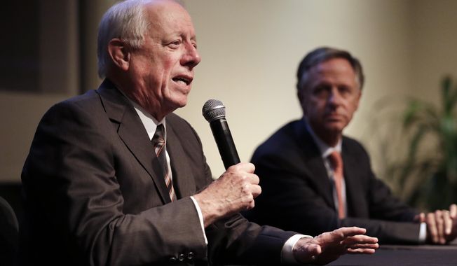 Former Democratic Gov. Phil Bredesen, left, answers a question during a discussion on bipartisanship at Vanderbilt University Tuesday, Nov. 5, 2019, in Nashville, Tenn. At right is former Republican Gov. Bill Haslam. (AP Photo/Mark Humphrey)