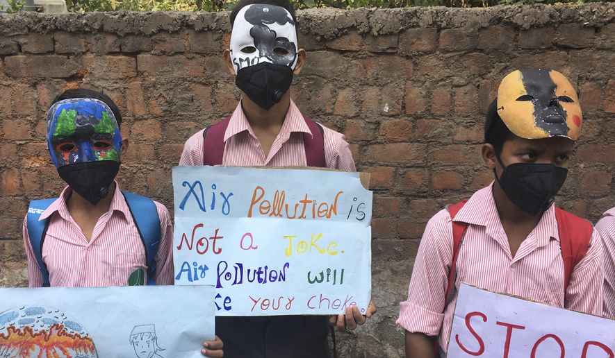 Schoolchildren protest outside the Indian Environment Ministry against alarming levels of pollution in the city, in New Delhi, India, Tuesday, Nov. 5, 2019. Air pollution in New Delhi and northern Indian states peaks in the winter as farmers in neighboring agricultural regions set fire to clear land after the harvest and prepare for the next crop season. The pollution in the Indian capital also peaks after Diwali celebrations, the Hindu festival of light, when people set off fireworks. (AP Photo/Shonal Ganguly)