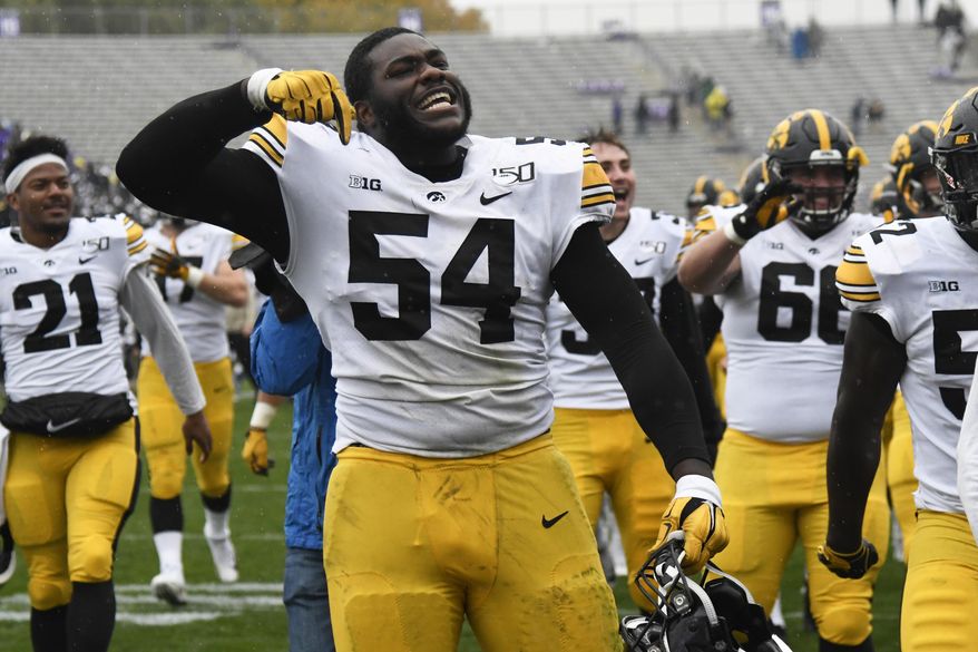 Iowa defensive tackle Daviyon Nixon (54) celebrates his teams 20-0 win against Northwestern during an NCAA college football game, Saturday, Oct. 26, 2019, in Evanston, Ill. (AP Photo/David Banks)