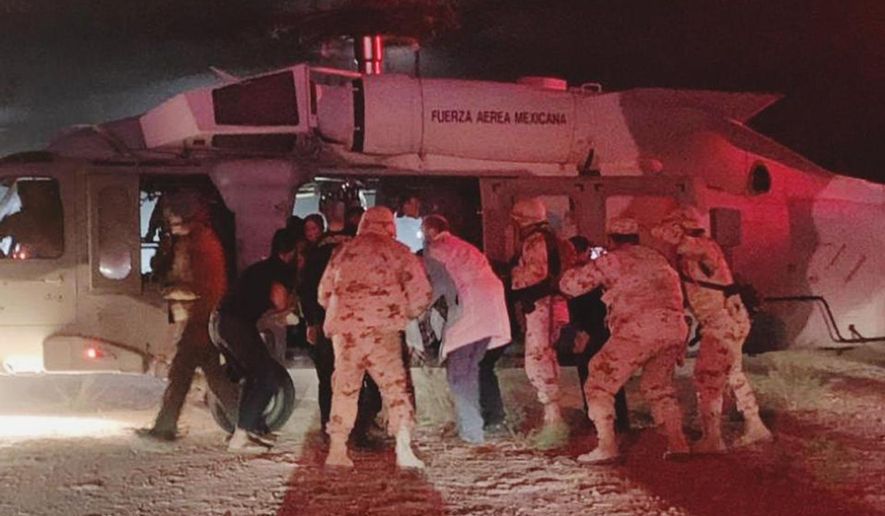 In this photo provided by the Sonora state Health Secretary, children of the extended LeBaron family, who were injured in an ambush are taken aboard a Mexican Airforce helicopter to be flown to the Mexico-U.S. border, from the border between the Mexican states of Chihuahua and Sonora, Monday, Nov.4, 2019. The children were injured when drug cartel gunmen ambushed three SUVs along a dirt road, slaughtering six children and three women, all U.S. citizens living in northern Mexico, in a grisly attack that left one vehicle a burned-out, bullet-riddled hulk. (Sonora state Health Secretary via AP)