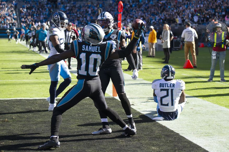 Carolina Panthers wide receiver Curtis Samuel (10) celebrates his touchdown against the Tennessee Titans as cornerback Malcolm Butler (21) sits on the turf during the first half of an NFL football game in Charlotte, N.C., Sunday, Nov. 3, 2019. (AP Photo/Mike McCarn)