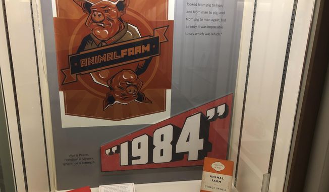 In this Oct. 21, 2019, photo, a poster promoting George Orwell&#x27;s novels &amp;quot;Animal Farm&amp;quot; and &amp;quot;1984&amp;quot; is shown at an exhibit in Albuquerque, N.M. celebrating the author&#x27;s legacy. The exhibit at the University of New Mexico is tackling the themes of the novelist&#x27;s work from &amp;quot;1984&amp;quot; to &amp;quot;Animal Farm.&amp;quot; &amp;quot;George Orwell: His Enduring Legacy,&amp;quot; which runs to April 2020, features posters and material related to work challenging totalitarianism. (AP Photo/ Russell Contreras)