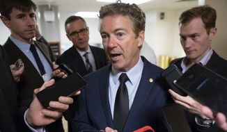 Sen. Rand Paul, R-Ky., responds to reporters at the Capitol after he threatened to reveal the name of the Ukraine whistleblower who helped initiate the impeachment inquiry against President Donald Trump by providing details of Trump&#x27;s call with the Ukrainian president, in Washington, Wednesday, Nov. 6, 2019. (AP Photo/J. Scott Applewhite)