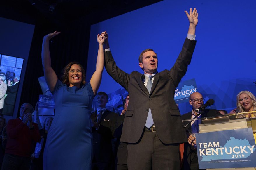 Democratic gubernatorial candidate and Kentucky Attorney General Andy Beshear, along with lieutenant governor candidate Jacqueline Coleman, acknowledge supporters at the Kentucky Democratic Party election night watch event, Tuesday, Nov. 5, 2019, in Louisville, Ky. (AP Photo/Bryan Woolston)