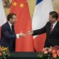 French President Emmanuel Macron, left, shakes hands with Chinese President Xi Jinping following a signing ceremony at the Great Hall of the People in Beijing, Wednesday, Nov. 6, 2019. (Nicolas Asfouri/Pool Photo via AP)