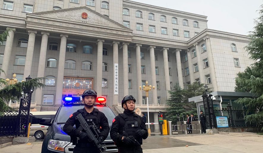Police stand guard outside the Xingtai Intermediate People’s court in Xingtai, China Thursday, Nov. 7, 2019. A Chinese court sentenced three fentanyl traffickers Thursday in a case that was a culmination of a rare collaboration between Chinese and U.S. law enforcement to crack down on global networks that manufacture and distribute lethal synthetic opioids. (AP Photo/Erika Kinetz)