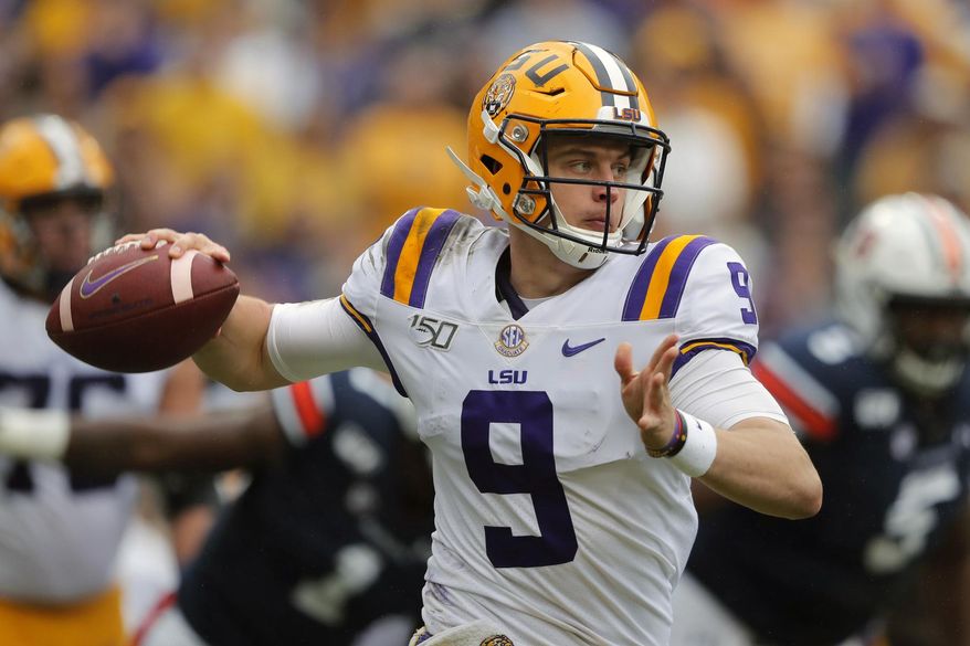 FILE - In this Oct. 26, 2019, file photo, LSU quarterback Joe Burrow (9) scrambles in the first half of an NCAA college football game against the Auburn, in Baton Rouge, La. For the first time in college football history, there will be two games matching teams of at least 8-0 on the same day, according to ESPN Facts and Info.In Tuscaloosa, Alabama, LSU and the Crimson Tide will play the first regular-season game matching AP Nos. 1 and 2 since 2011 _ when No. 1 LSU beat No. 2 Alabama 9-6 in overtime. (AP Photo/Gerald Herbert, File)