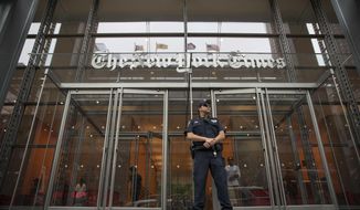 FILE- In this June 28, 2018, file photo, a police officer stands guard outside The New York Times building in New York. The New York Times Co. reports financial results Wednesday, Nov. 6, 2019. (AP Photo/Mary Altaffer, File)