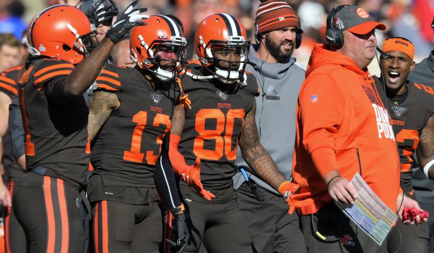 FILE - In this Sunday, Oct. 13, 2019, file photo, Cleveland Browns players encourage head coach Freddie Kitchens to throw a challenge flag during an NFL football game against the Seattle Seahawks, in Cleveland. Being a rookie head coach in the NFL is challenging enough, and also calling plays for the offense only increases the difficulty. Kitchens is finding himself criticized and second-guessed for trying to do too much halfway through his first season. (AP Photo/David Richard, File)