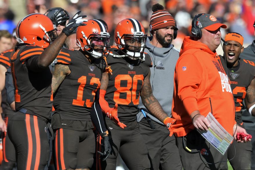 FILE - In this Sunday, Oct. 13, 2019, file photo, Cleveland Browns players encourage head coach Freddie Kitchens to throw a challenge flag during an NFL football game against the Seattle Seahawks, in Cleveland. Being a rookie head coach in the NFL is challenging enough, and also calling plays for the offense only increases the difficulty. Kitchens is finding himself criticized and second-guessed for trying to do too much halfway through his first season. (AP Photo/David Richard, File)