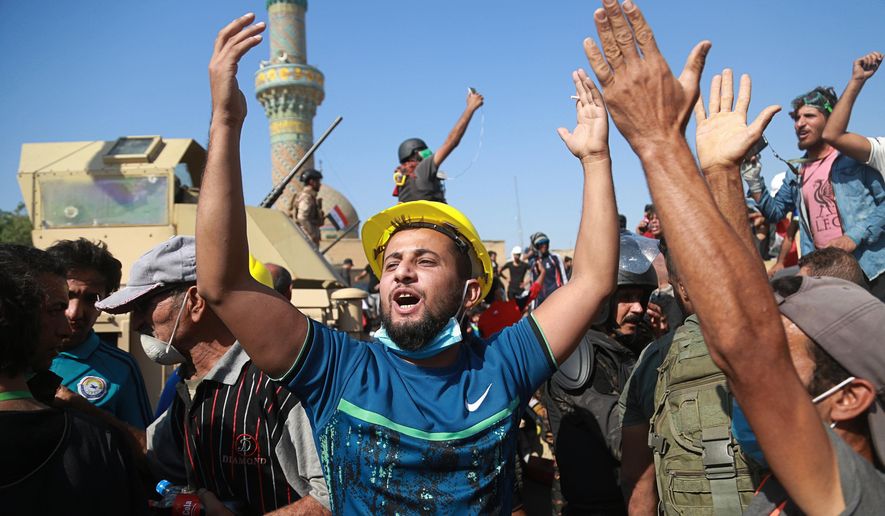 Anti-government protesters try to cross the al- Shuhada (Martyrs) bridge in central Baghdad, Iraq, Wednesday, Nov. 6, 2019. The rallies that have gripped in Iraq and similar demonstrations underway in Lebanon pose a threat to some of Iran&#x27;s main regional allies as Tehran faces mounting pressure from U.S. sanctions. (AP Photo/Hadi Mizban) ** FILE **