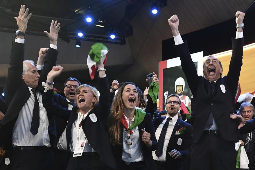 FILE - In this Monday, June 24, 2019 file photo, members of the Milan-Cortina delegation celebrate after winning the bid to host the 2026 Winter Olympic Games, during the first day of the 134th Session of the International Olympic Committee (IOC), at the SwissTech Convention Centre, in Lausanne, Switzerland. Former telecommunications chief Vincenzo Novari has been named the CEO of the organizing committee for the Milan-Cortina 2026 Winter Olympics. (Philippe Lopez/Pool via AP, File)