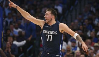 Dallas Mavericks guard Luka Doncic gestures after sinking a basket during the first half against the Orlando Magic in an NBA basketball game Wednesday, Nov. 6, 2019, in Dallas. (AP Photo/Richard W. Rodriguez)