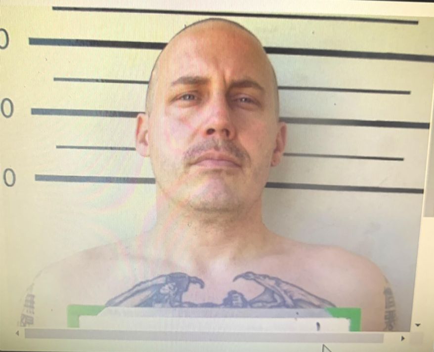 In this undated image made from a digital screen released by Thailand's Department of Corrections, shows a police custody photo of American citizen Bart Allen Helmus, 40 years old, after being arrested on drug charges. Helmus was among three prisoners who staged a violent escape from a courthouse in Thailand has shot and injured himself and his wife as police surrounded them Wednesday, Nov. 6, 2019. (Thailand Department of Corrections via AP)