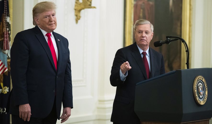 President Donald Trump listens to Sen. Lindsey Graham, R-S.C., speak during a ceremony in the East Room of the White House where Trump spoke about his judicial appointments, Wednesday, Nov. 6, 2019, in Washington. (AP Photo/Manuel Balce Ceneta)