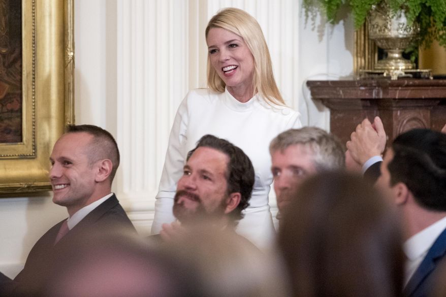 In this April 1, 2019, photo, former Florida attorney general Pam Bondi is recognized by President Donald Trump at the 2019 Prison Reform Summit and First Step Act Celebration in the East Room of the White House in Washington. The White House is beefing up its communications staff as it tries to grapple with the ongoing House impeachment investigation. A senior administration official tells The Associated Press that Bondi, and Tony Sayegh, a former Treasury Department spokesman, are expected to join the White House communications team to work on “proactive impeachment messaging” and other special projects. (AP Photo/Andrew Harnik, file)