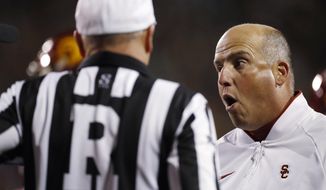 Southern California coach Clay Helton, right, argues with referee Mike McCabe for a call against Colorado during the second half of an NCAA college football game Friday, Oct. 25, 2019, in Boulder, Colo. Southern California won 35-31. (AP Photo/David Zalubowski)