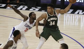 Milwaukee Bucks&#39; Giannis Antetokounmpo (34) is defended by Los Angeles Clippers&#39; Patrick Beverley (21) during the first half of an NBA basketball game Wednesday, Nov. 6, 2019, in Los Angeles. (AP Photo/Marcio Jose Sanchez)