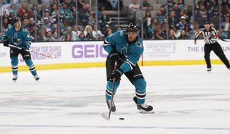San Jose Sharks left wing Evander Kane (9) looks to pass the puck against the Vancouver Canucks during the first period of an NHL hockey game Saturday, Nov. 2, 2019, in San Jose, Calif. (AP Photo/Jim Gensheimer)