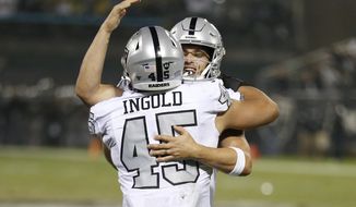 Oakland Raiders running back Alec Ingold (45) celebrates with quarterback Derek Carr after they connected on a touchdown pass against the Los Angeles Chargers during the first half of an NFL football game in Oakland, Calif., Thursday, Nov. 7, 2019. (AP Photo/D. Ross Cameron)