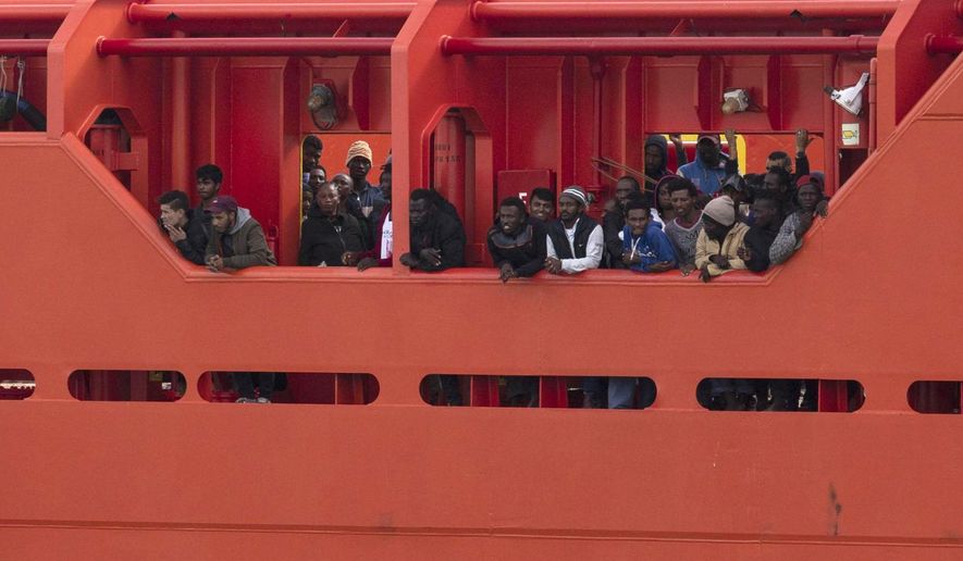 Migrants wait to disembark from the Asso Trenta ship, as it reaches the port of Pozzallo, Italy, Sunday, Nov. 3, 2019. An Italian offshore supply vessel has brought 151 migrants to Sicily after rescuing them in waters off Libya a day earlier. (Francesco Ruta/ANSA via AP)