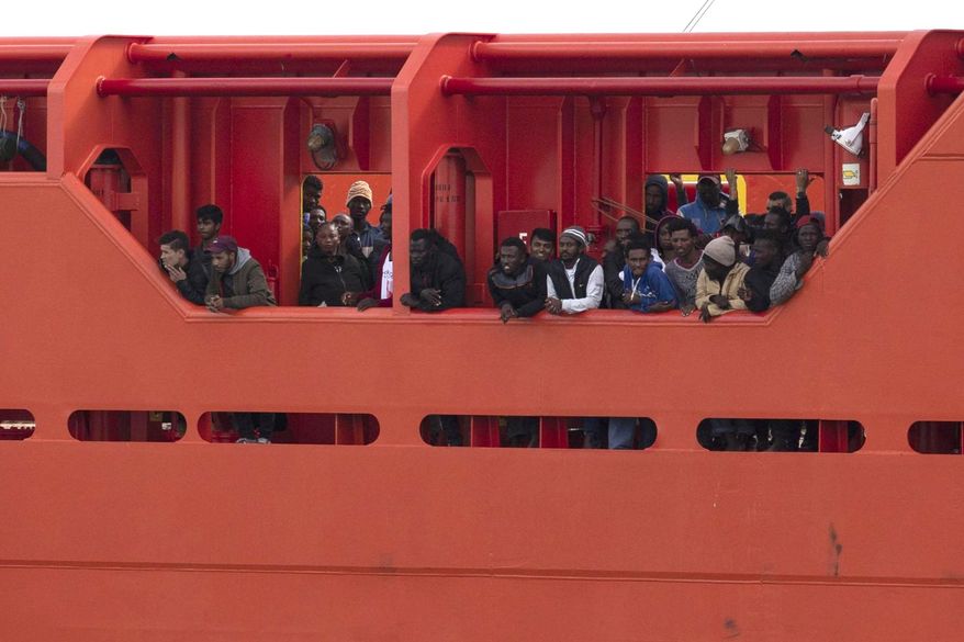 Migrants wait to disembark from the Asso Trenta ship, as it reaches the port of Pozzallo, Italy, Sunday, Nov. 3, 2019. An Italian offshore supply vessel has brought 151 migrants to Sicily after rescuing them in waters off Libya a day earlier. (Francesco Ruta/ANSA via AP)