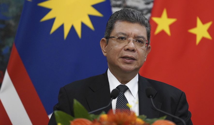 FILE - In this Sept. 12, 2019, file photo, Malaysian Foreign Minister Saifuddin Abdullah speaks during a press conference at the end of a meeting with Chinese Foreign Minister Wang Yi at the Diaoyutai State Guesthouse in Beijing. Malaysia has rejected a U.S. plan to host an Asia-Pacific trade summit in January, after Chile scrapped the November meeting over violent anti-government protests. (Andrea Verdelli/Pool Photo via AP, FIle)