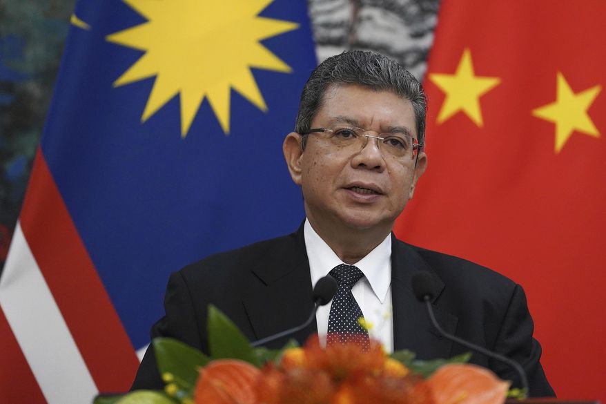 FILE - In this Sept. 12, 2019, file photo, Malaysian Foreign Minister Saifuddin Abdullah speaks during a press conference at the end of a meeting with Chinese Foreign Minister Wang Yi at the Diaoyutai State Guesthouse in Beijing. Malaysia has rejected a U.S. plan to host an Asia-Pacific trade summit in January, after Chile scrapped the November meeting over violent anti-government protests. (Andrea Verdelli/Pool Photo via AP, FIle)
