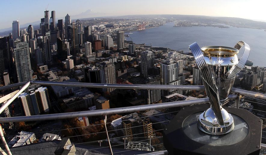 In this Nov. 5, 2019, photo, the MLS Cup trophy is displayed on the roof of the Space Needle with the downtown Seattle in the background. Seattle will host the MLS Cup soccer match Sunday, Nov. 10, 2019, as the Seattle Sounders face Toronto FC at CenturyLink Field. Ten years ago, the arrival of the Sounders changed expectations for what an MLS soccer expansion team should look like, and now the soccer-mad city gets a chance to shine hosting the league's championship game for the second time, but the first with the home team playing. (AP Photo/Ted S. Warren)