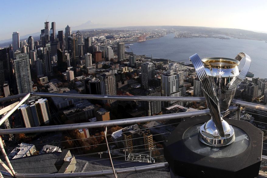 In this Nov. 5, 2019, photo, the MLS Cup trophy is displayed on the roof of the Space Needle with the downtown Seattle in the background. Seattle will host the MLS Cup soccer match Sunday, Nov. 10, 2019, as the Seattle Sounders face Toronto FC at CenturyLink Field. Ten years ago, the arrival of the Sounders changed expectations for what an MLS soccer expansion team should look like, and now the soccer-mad city gets a chance to shine hosting the league's championship game for the second time, but the first with the home team playing. (AP Photo/Ted S. Warren)