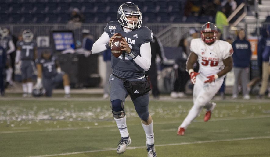 Nevada quarterback Carson Strong (12 ) rolls out against New Mexico second half of an NCAA college football game in Reno, Nev., Saturday, Nov. 2, 2019. (AP Photo/Tom R. Smedes)