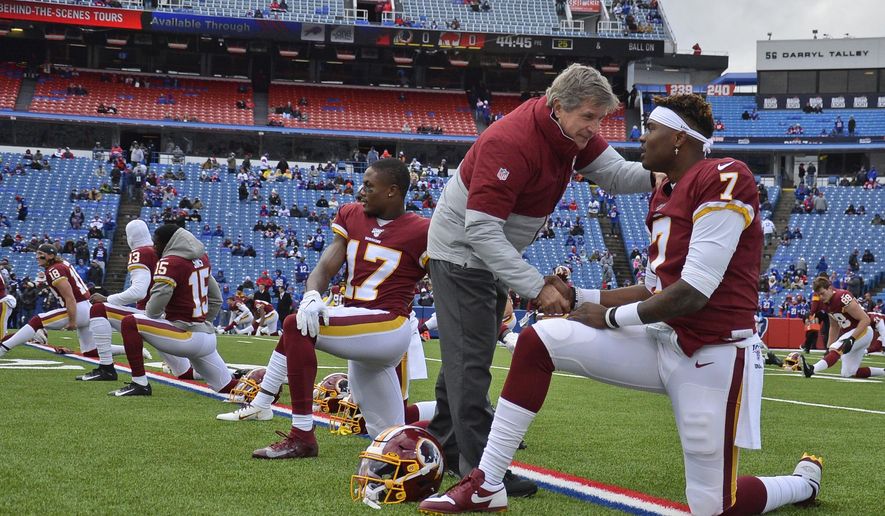 FILE - In this Nov. 3, 2019, file photo, Washington Redskins head coach Bill Callahan, left, talks with quarterback Dwayne Haskins before an NFL football game in Orchard Park, N.Y. The Redskins at the bye week of a lost season are a team without a definitive answer at quarterback, answers to questions on offense and defense and a visible organizational plan for the future. Callahan has repeatedly set the expectation at winning the next game and said he’s receiving no direction from the front office on how to develop young players for the next few years. (AP Photo/Adrian Kraus, File)