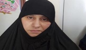 Undated handout photo made available by unnamed government sources showing a woman identified as Asma Fawzi Muhammad al-Qubaysi, a wife of the slain leader of the Islamic State group Abu Bakr al-Baghdadi. Turkey has captured a wife of the slain leader of the Islamic State group, Abu Bakr al-Baghdadi, Turkish President Recep Tayyip Erdogan said Wednesday Nov. 6, 2019. A senior Turkish official said the woman was among a group of 11 Islamic State suspects detained in a police operation in Turkey&#39;s Hatay province, near the border with Syria, on June 2, 2018.(Handout via AP)