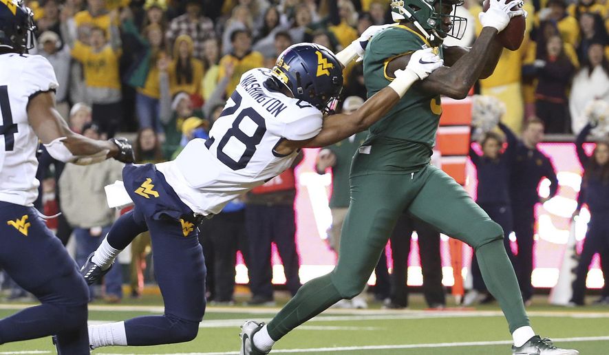 Baylor wide receiver Denzel Mims (5) catches a pass for a touchdown next to West Virginia cornerback Keith Washington Jr. (28) during the second half of an NCAA college football game in Waco, Texas, Thursday, Oct. 31, 2019. (AP Photo/Jerry Larson)